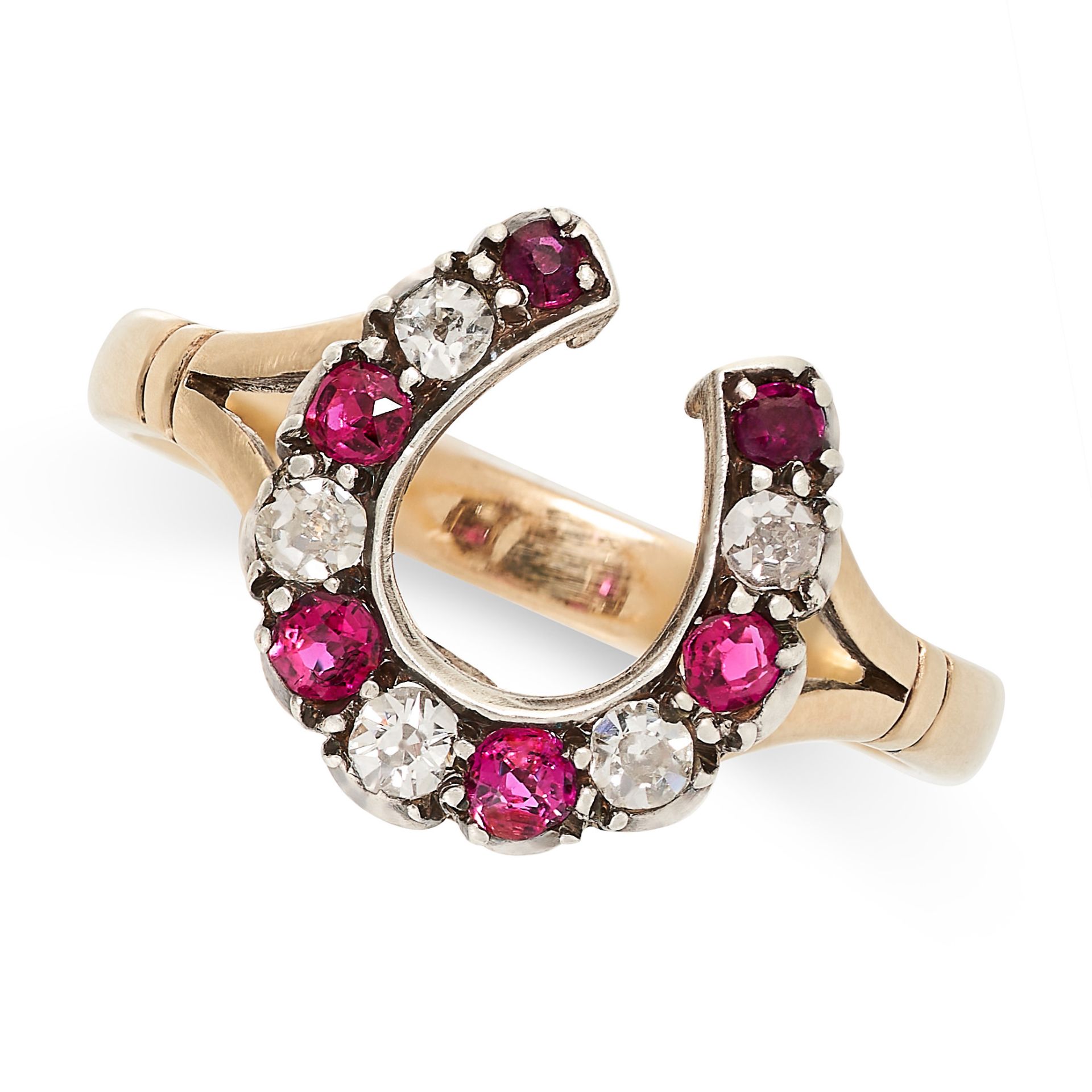 A RUBY AND DIAMOND HORSESHOE RING in yellow gold and silver, set with six round cut rubies and