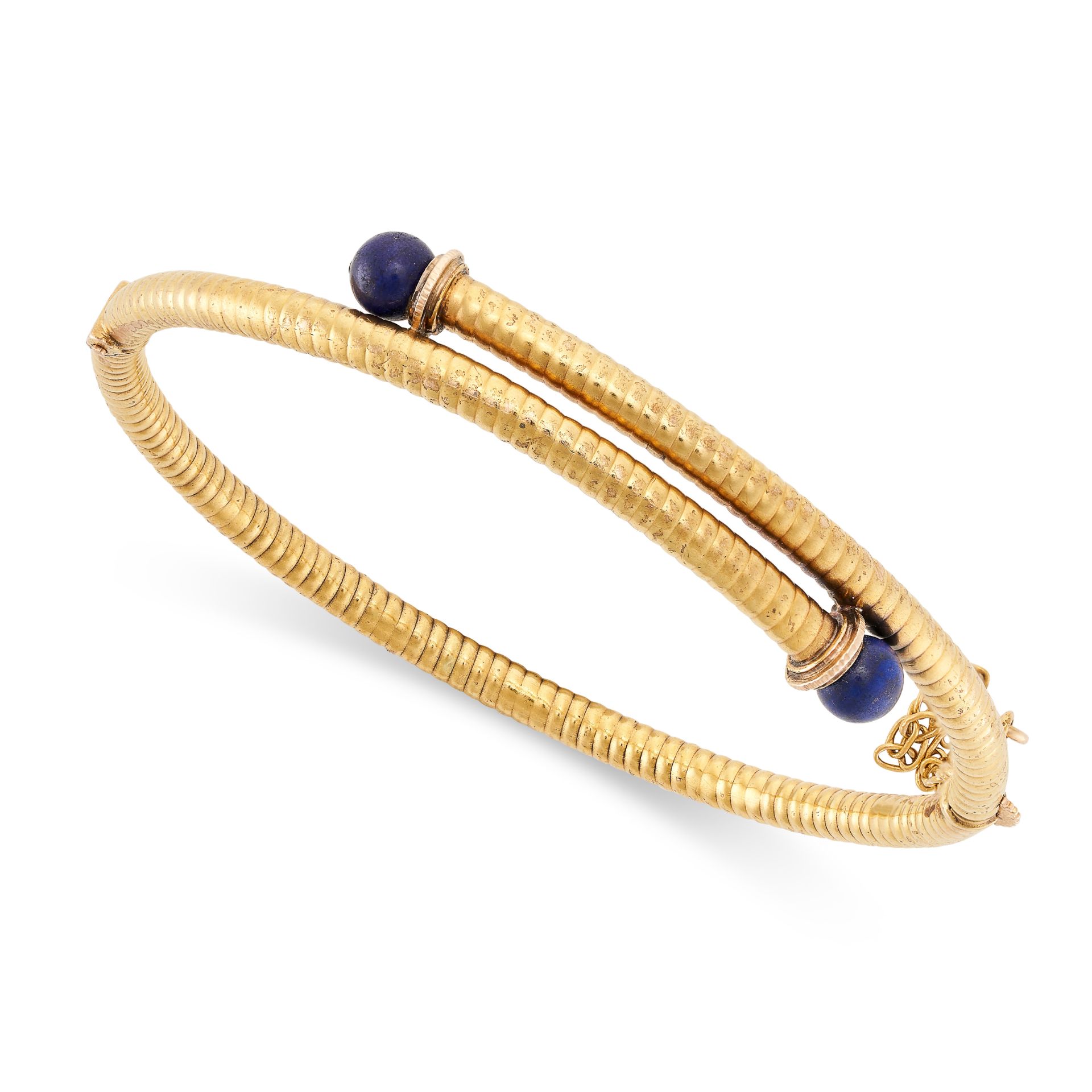 AN ANTIQUE LAPIS LAZULI BANGLE, LATE 19TH CENTURY in 15ct yellow gold, the hinged body of reeded