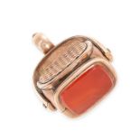 AN ANTIQUE ONYX INTAGLIO AND CARNELIAN ROTATING FOB SEAL PENDANT in yellow gold, the rotating body