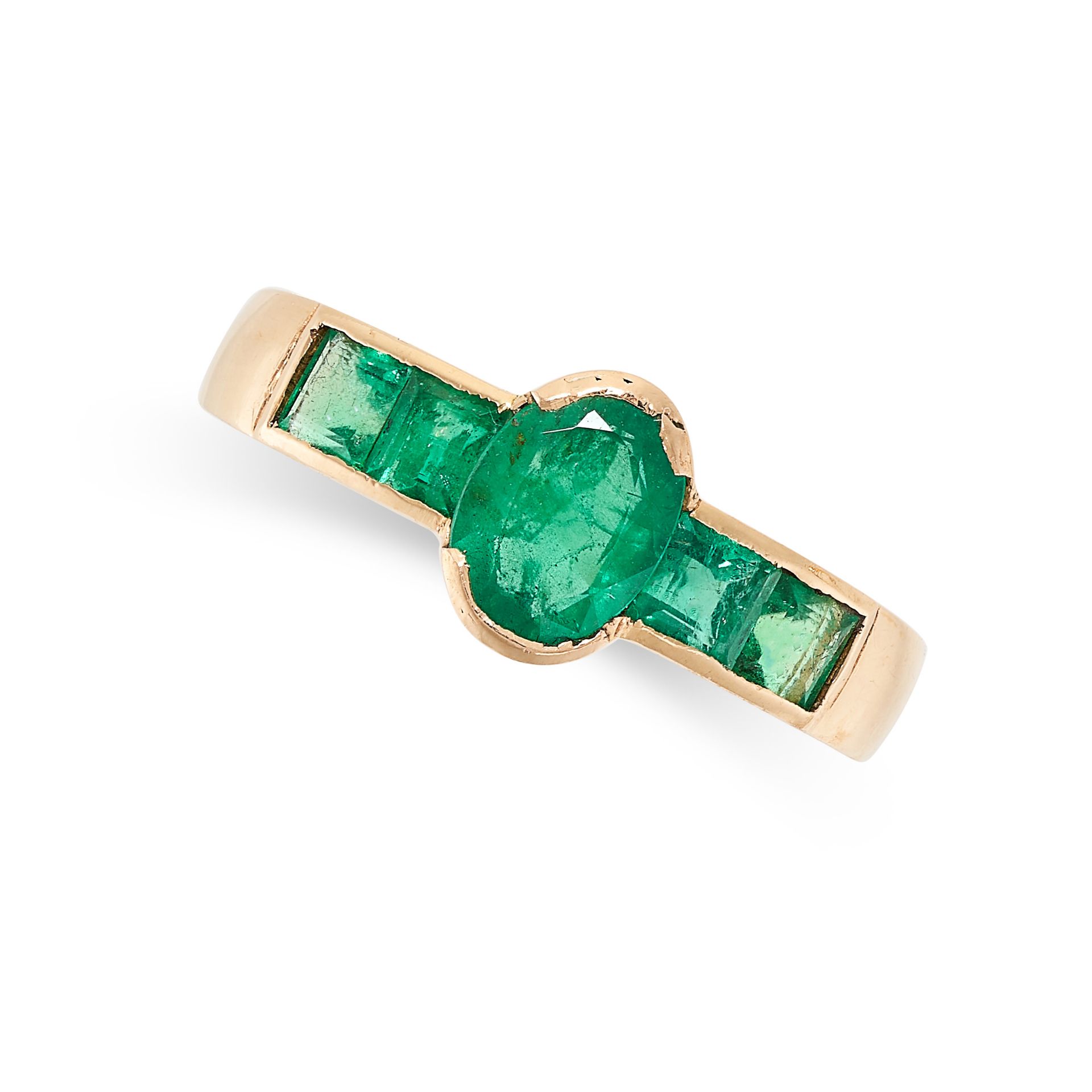 AN EMERALD DRESS RING in 18ct yellow gold, the band set with an oval cut emerald between step cut