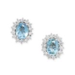 A PAIR OF AQUAMARINE AND DIAMOND CLUSTER EARRINGS each set with an oval cut aquamarine within a