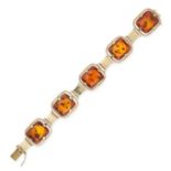 A VINTAGE AMBER BRACELET in yellow gold, set with five pieces of polished amber accented by gold