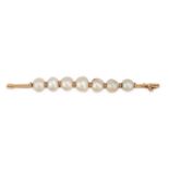 A PEARL BAR BROOCH set with a row of seven pearls, 9.1cm, 10.3g.