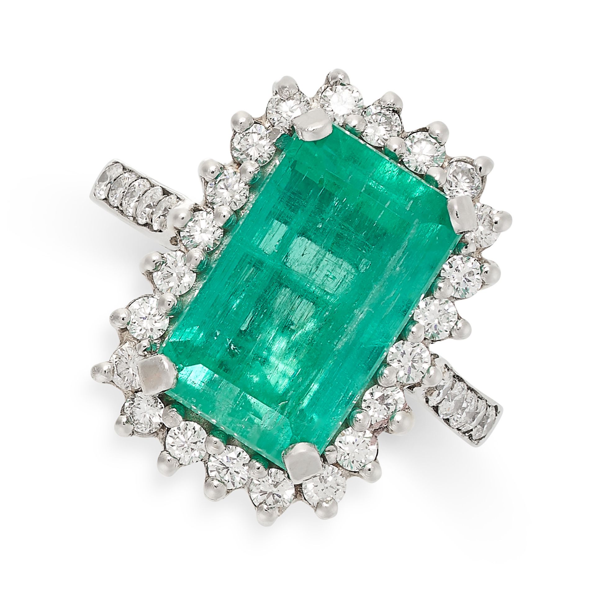 AN EMERALD AND DIAMOND CLUSTER RING in platinum, set with an octagonal cut emerald of 5.60 carats,