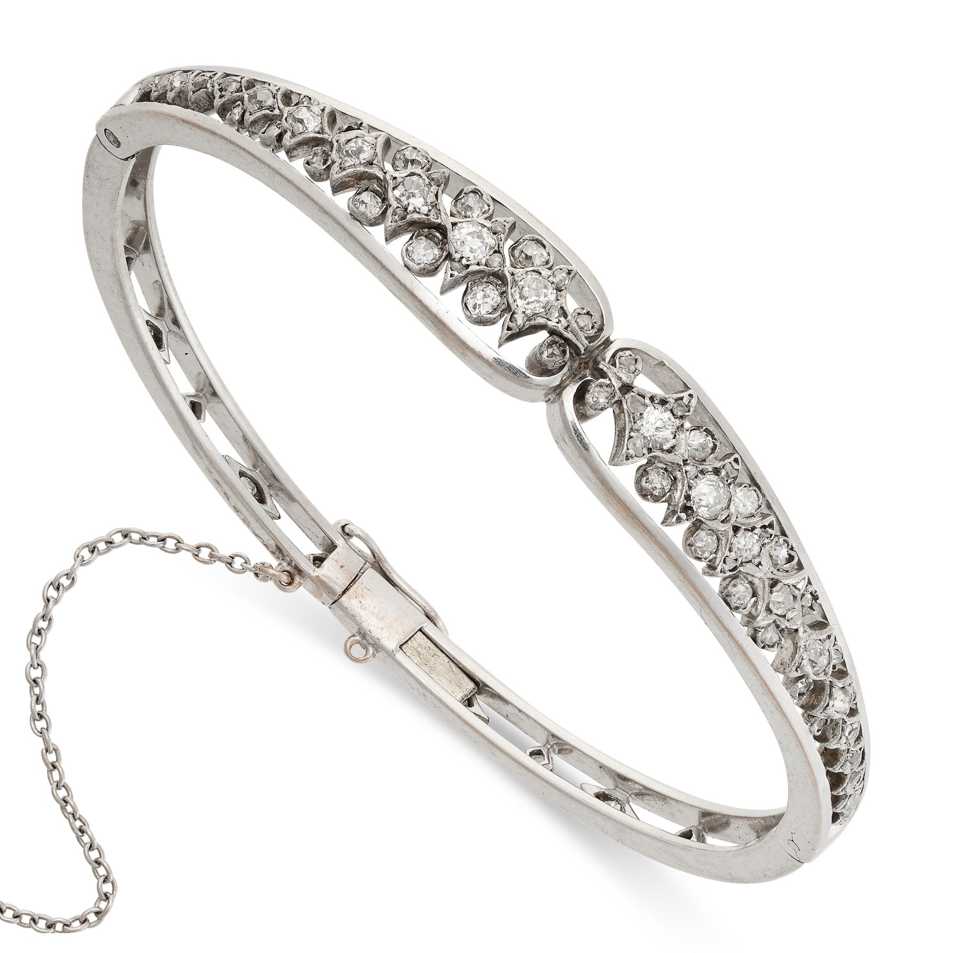 AN ANTIQUE DIAMOND BANGLE, EARLY 20TH CENTURY the foliate motifs set with a row of old cut