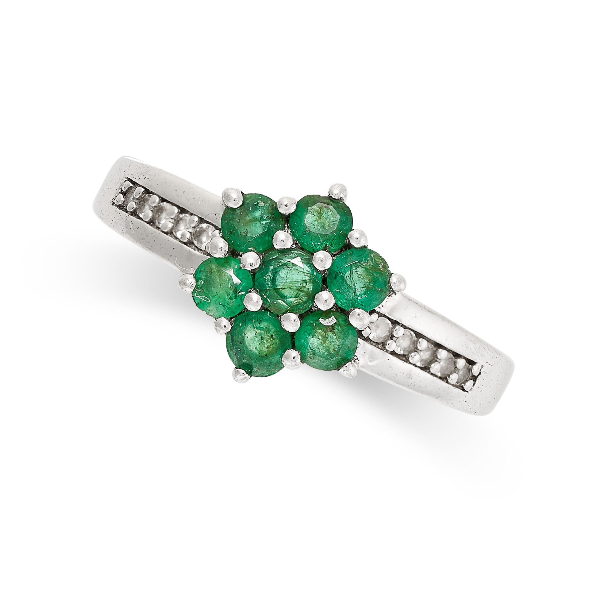 AN EMERALD DRESS RING in sterling silver, set with a cluster of round cut emeralds, accented by rows