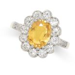 A YELLOW SAPPHIRE AND DIAMOND CLUSTER RING set with a central oval cut yellow sapphire of 1.87