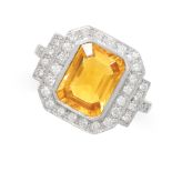 A VINTAGE YELLOW SAPPHIRE AND DIAMOND RING in platinum, set with a central octagonal step cut yellow