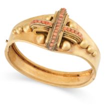 AN ANTIQUE CORAL BANGLE, 19TH CENTURY in yellow gold, the centre applied with a cross shaped motif