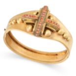 AN ANTIQUE CORAL BANGLE, 19TH CENTURY in yellow gold, the centre applied with a cross shaped motif