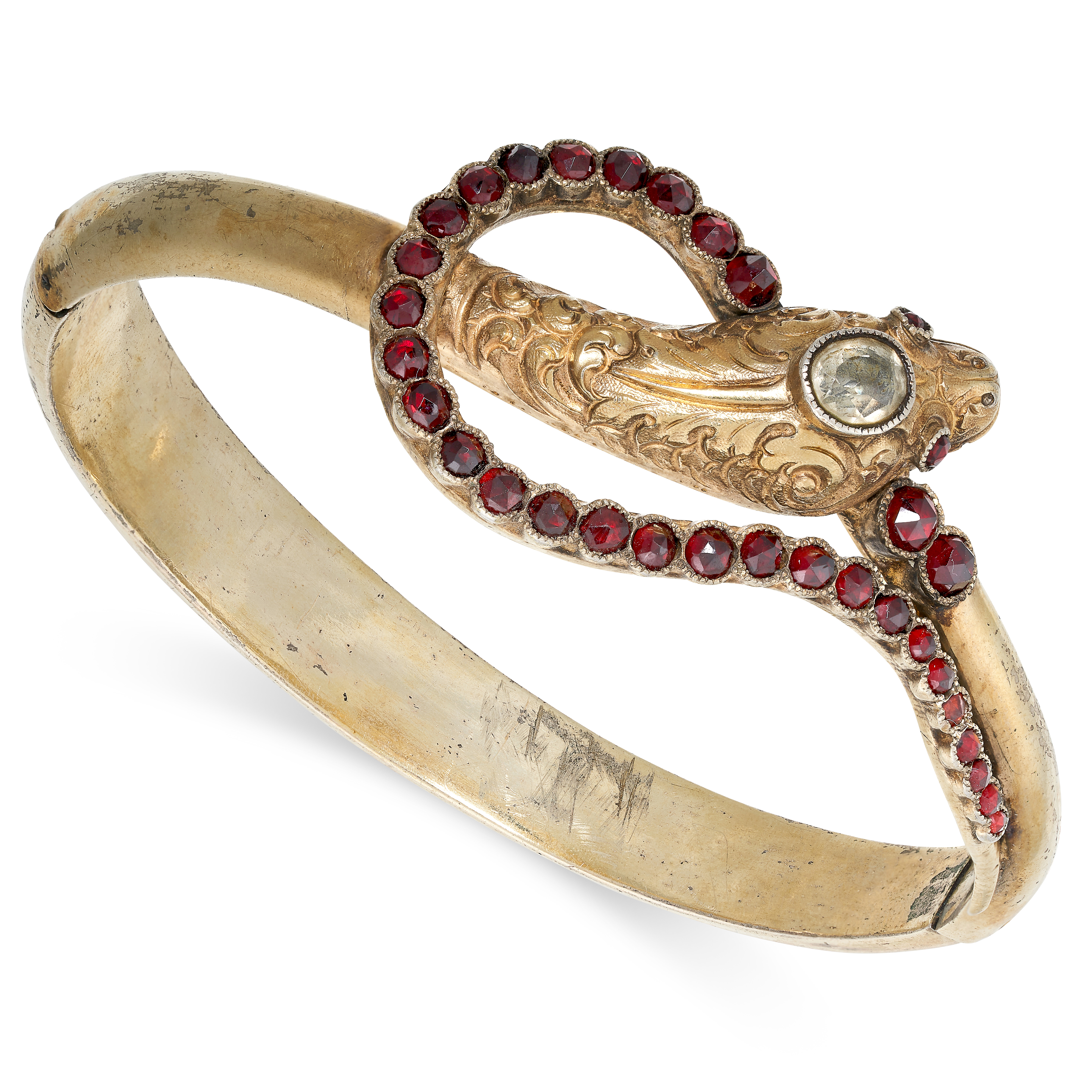 AN ANTIQUE GARNET AND PASTE SNAKE BANGLE designed as a snake coiled around on itself, the hinged