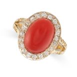 A DIAMOND AND CORAL RING in yellow gold, set with a polished oval piece of coral in a border of