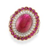 A RUBY AND DIAMOND DRESS RING in yellow gold and silver, set with an oval cabochon ruby in a