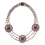 AN ANTIQUE GARNET NECKLACE comprising three oval plaques set with oval and round cut garnets on a