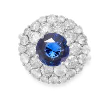 A SAPPHIRE AND DIAMOND CLUSTER RING in 18ct white gold, set with a round cut sapphire of 2.52 carats