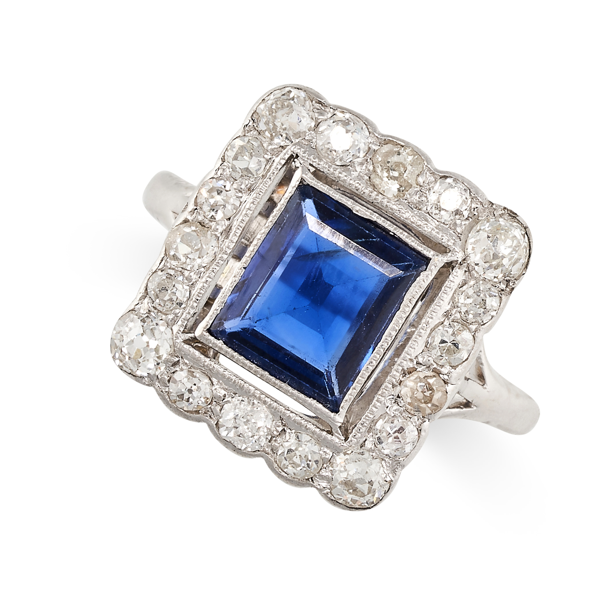 A SAPPHIRE AND DIAMOND RING set with a rectangular step cut blue sapphire of 1.24 carats within a