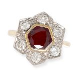 A RUBY AND DIAMOND CLUSTER RING in 18ct gold set centrally with a hexagonal cut ruby held in a