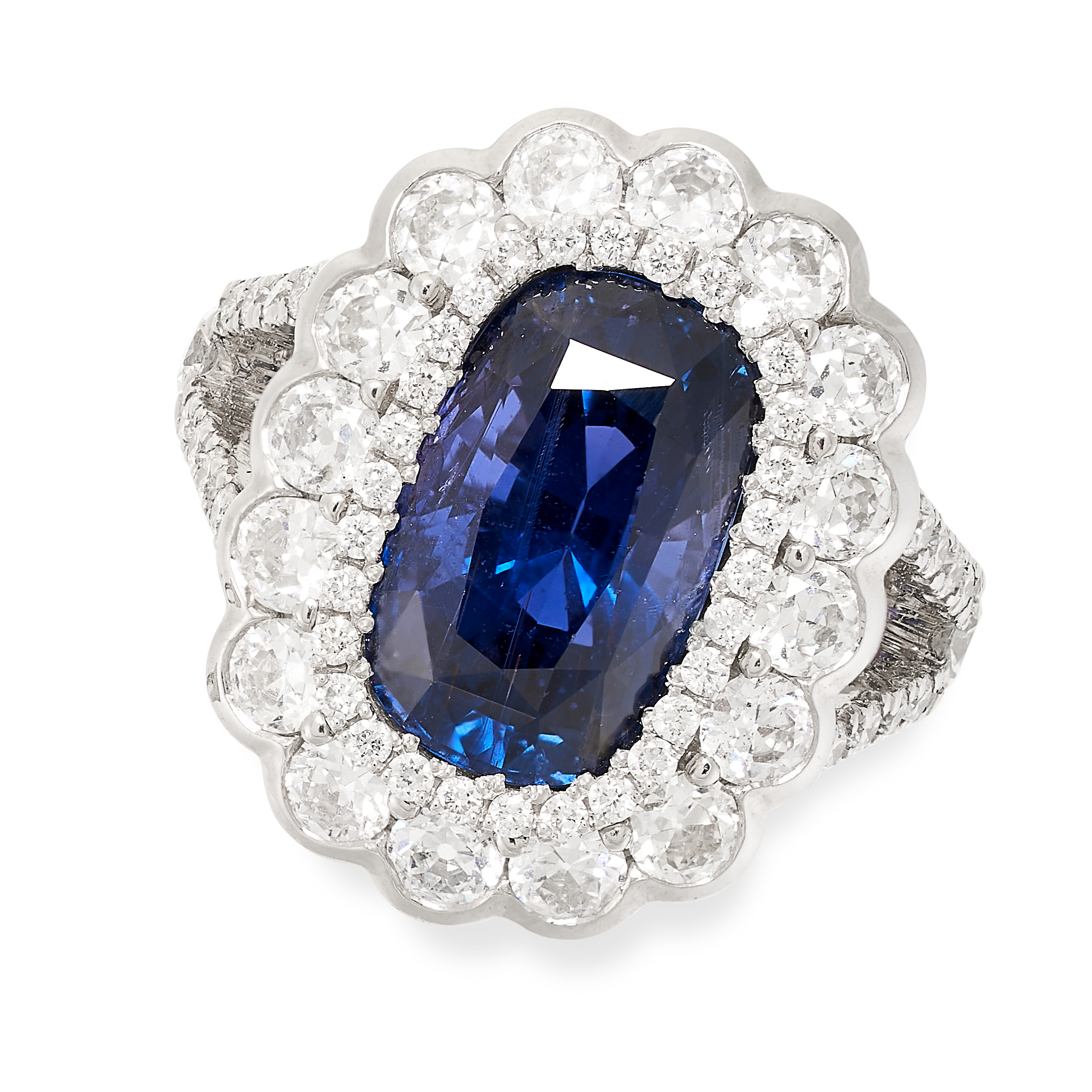 AN UNHEATED SAPPHIRE AND DIAMOND CLUSTER RING in platinum, set with a central cushion cut sapphire