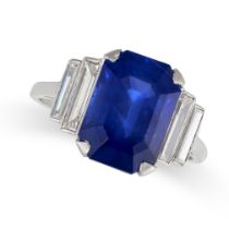 AN ART DECO SAPPHIRE AND DIAMOND DRESS RING in platinum, set with an emerald cut blue sapphire of