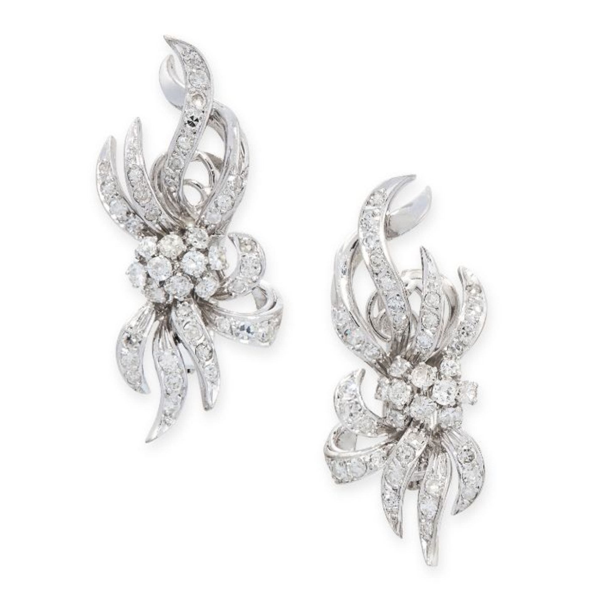 A PAIR OF DIAMOND CLIP EARRINGS the scrolling bodies set throughout with round cut and single cut