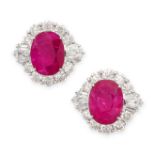 A PAIR OF RUBY AND DIAMOND STUD EARRINGS each set with an oval cut ruby within a cluster of round