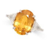 A YELLOW SAPPHIRE AND DIAMOND RING set with an oval cut yellow sapphire of 7.20 carats between two