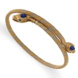 AN ANTIQUE SAPPHIRE AND EMERALD SNAKE BANGLE in tricolour gold, the body designed as two snakes