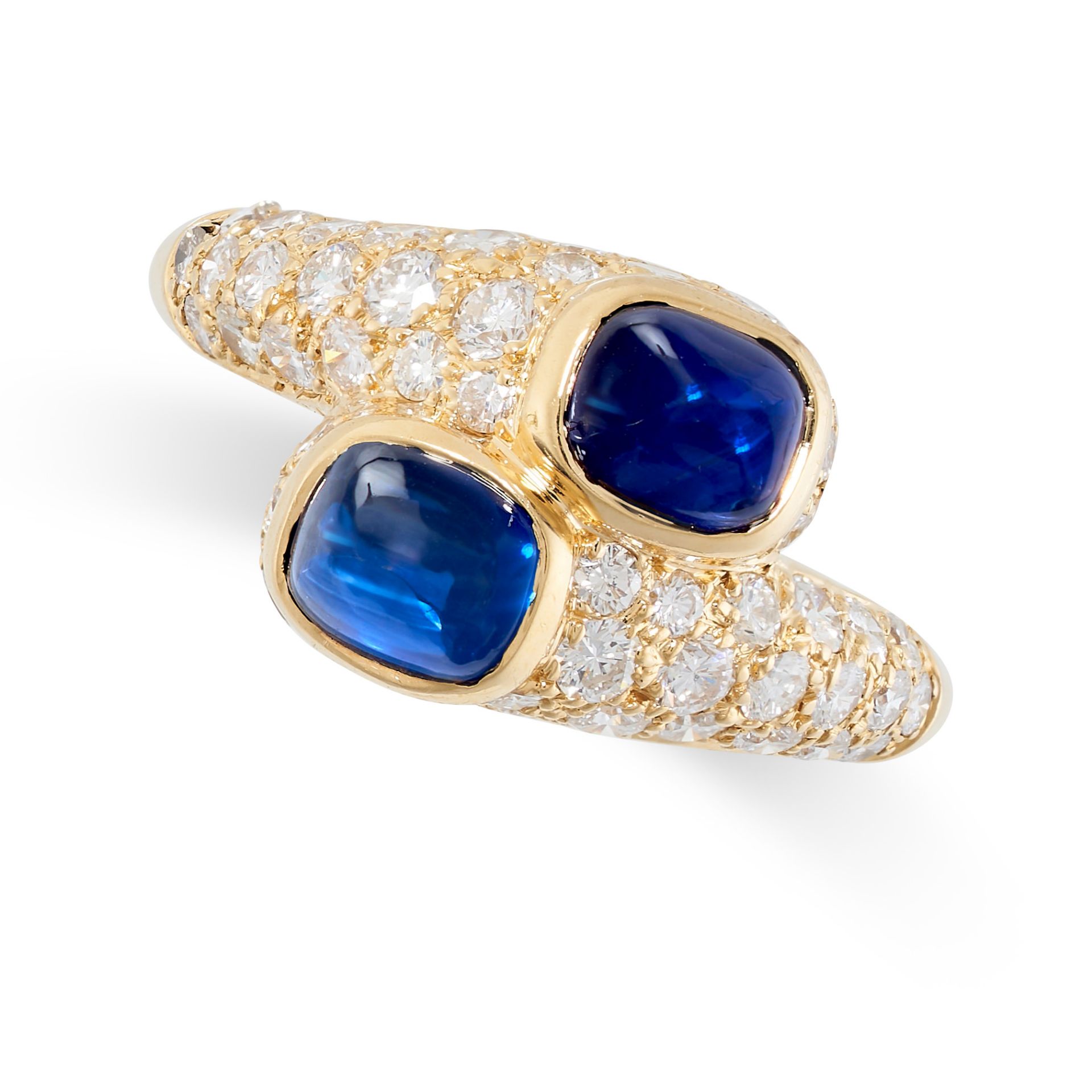 CARTIER, A SAPPHIRE AND DIAMOND CROSSOVER RING in 18ct yellow gold, set with two cabochon
