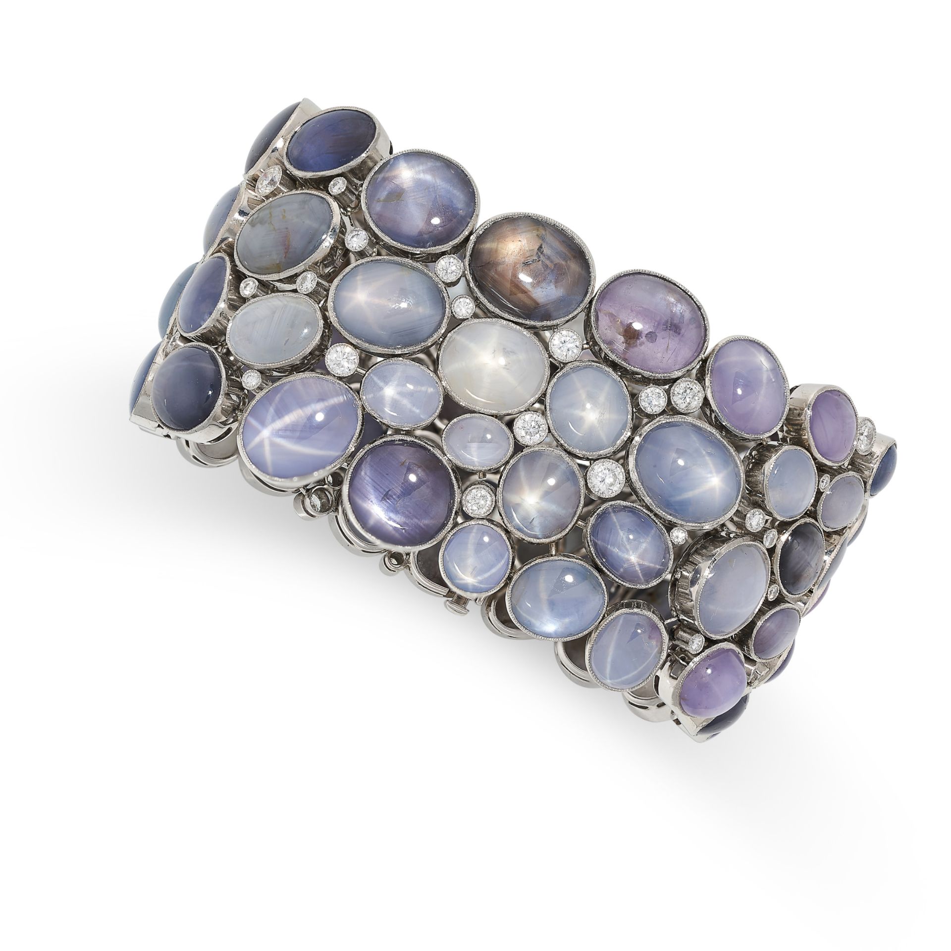 A STAR SAPPHIRE AND DIAMOND BRACELET comprising four rows of various coloured cabochon star