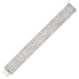 A FRENCH ART DECO DIAMOND BRACELET in platinum, in scrolling design, the pierced rectangular links