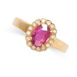 A RUBY AND DIAMOND CLUSTER RING in 18ct yellow gold, set with a central oval cut ruby of 1.19 carats