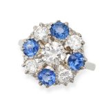 A SAPPHIRE AND DIAMOND RING set with a round brilliant cut diamond in a border of alternating