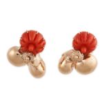 A PAIR OF VINTAGE CORAL CLIP EARRINGS in 14ct yellow gold, each set with a carved piece of coral