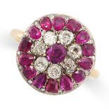 AN ANTIQUE RUBY AND DIAMOND CLUSTER RING in yellow gold and silver, set with a cushion cut ruby in a
