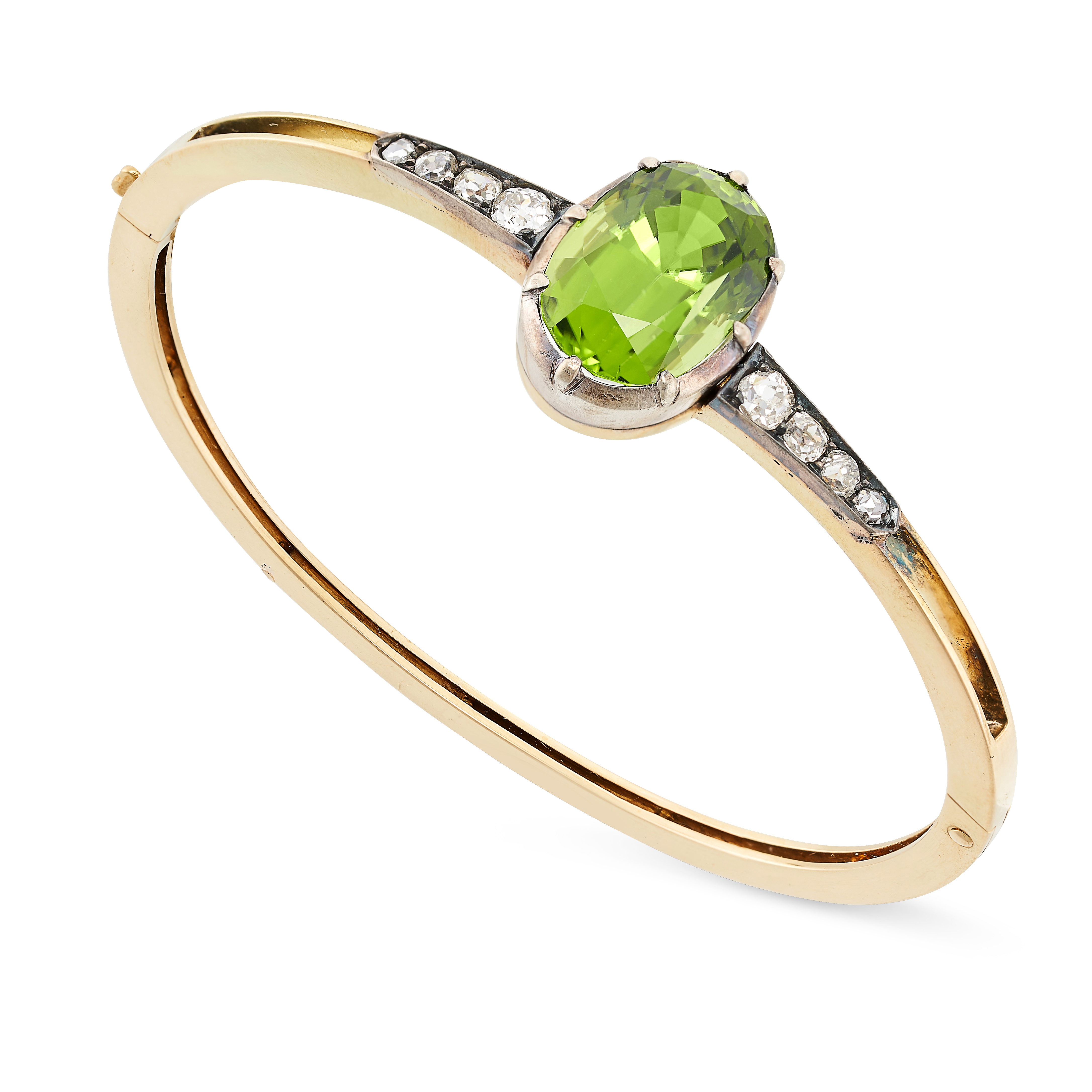 AN ANTIQUE PERIDOT AND DIAMOND BANGLE in yellow gold and silver, the hinged body set to the front