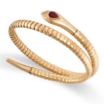A VINTAGE RUBY AND DIAMOND SNAKE BANGLE in yellow gold, the articulated body designed to depict a