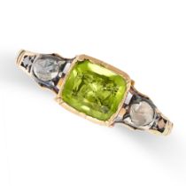 AN ANTIQUE PERIDOT AND DIAMOND RING in yellow gold and silver, set with a cushion cut peridot