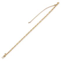 A DIAMOND BRACELET in 18ct yellow gold, set with a row of round brilliant cut diamonds accented by