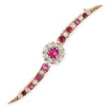 AN ANTIQUE RUBY AND DIAMOND BAR BROOCH in yellow gold, set with a cushion cut ruby within a border