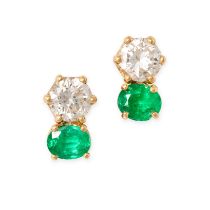 A PAIR OF EMERALD AND DIAMOND EARRINGS in 18ct yellow gold, each set with an oval cut emerald and