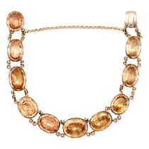 A FINE ANTIQUE IMPERIAL TOPAZ BRACELET, 19TH CENTURY in yellow gold, set with ten graduated oval cut