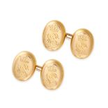 A PAIR OF ANTIQUE ENGRAVED GOLD CUFFLINKS in yellow gold, each formed of two oval faces inscribed