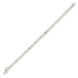 A DIAMOND LINE BRACELET in 18ct white gold, set with a row of sixty six baguette cut diamonds, the