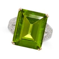 A PERIDOT AND DIAMOND RING in white gold and yellow gold, set with a central emerald cut peridot