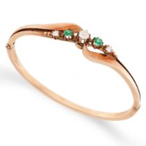 AN EMERALD AND DIAMOND BANGLE in yellow gold, the hinged body set with old cut and round brilliant
