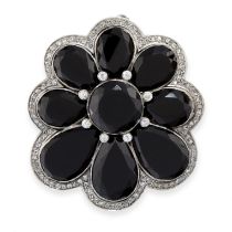 AN ONYX AND DIAMOND PENDANT / BROOCH, EARLY 20TH CENTURY of scalloped design, set with a cluster