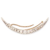 A DIAMOND CRESCENT MOON BROOCH in yellow gold and silver, set with a single row of graduated old cut