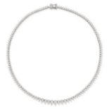 A DIAMOND LINE NECKLACE in platinum, formed of a series of graduated drop shaped links set