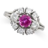 A RUBY AND DIAMOND CLUSTER RING in white gold, set centrally with a round cut ruby of 0.62 carats,