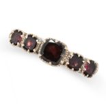 AN ANTIQUE GARNET RING in yellow gold, set with five cushion cut garnets, no assay marks, size L /